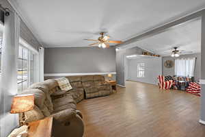 Living room featuring a textured ceiling, light wood-type flooring, and ceiling fan