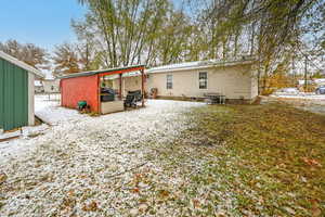 View of snow covered back of property