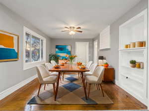 Dining area with wood-type flooring and ceiling fan