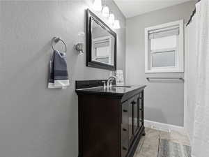 Bathroom featuring vanity and tile patterned floors