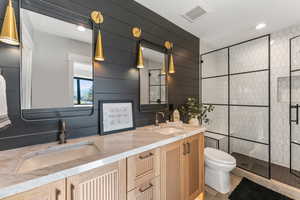 Bathroom with walk in shower, vanity, tile patterned floors, and toilet