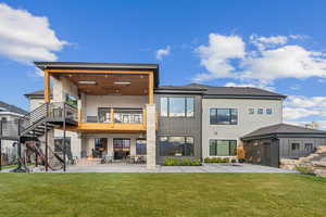 Back of property featuring a yard and a patio