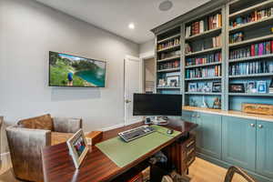 Home office with light wood-type flooring