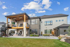 Rear view of property with a balcony, a yard, and a patio area