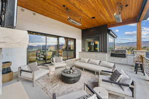 View of patio with outdoor lounge area, area for grilling, a mountain view, and a grill