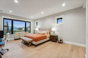 Bedroom with light wood-type flooring and a mountain view