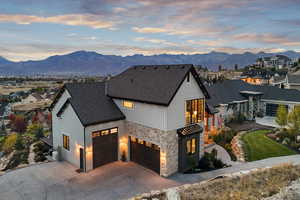 Modern farmhouse with a garage, a mountain view, and a balcony