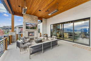 View of patio / terrace featuring a mountain view and an outdoor living space with a fireplace