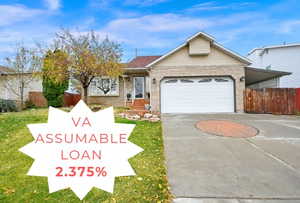 View of front of property featuring a front yard and a garage