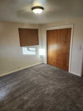 Unfurnished bedroom with carpet flooring and a closet