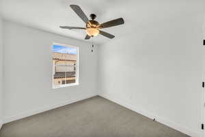 Spare room with ceiling fan and carpet floors