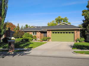 Ranch-style home with a garage and a front yard