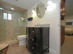 Bathroom with walk in shower, vanity, and toilet