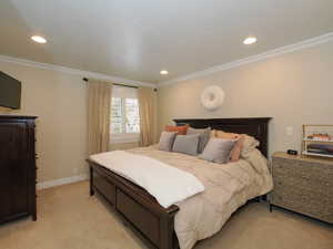 Carpeted bedroom featuring ornamental molding