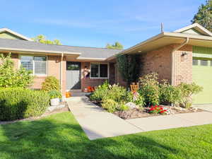 Ranch-style house with a garage and a front yard