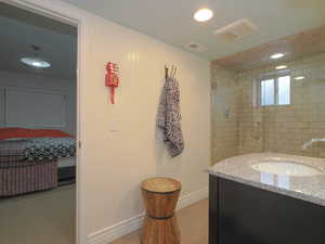 Bathroom with vanity and a shower with shower door