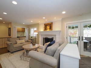 Living room featuring a fireplace, french doors, and hardwood / wood-style floors