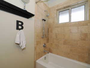 Bathroom featuring tiled shower / bath