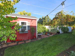 View of yard with a storage unit