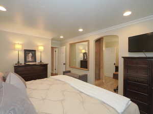 Bedroom featuring light hardwood / wood-style floors and crown molding