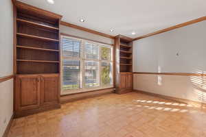 Spare room featuring ornamental molding and light parquet floors