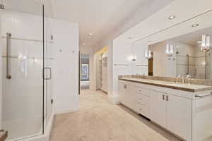 Bathroom with vanity and a shower with shower door