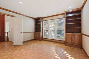 Spare room with light parquet floors and ornamental molding