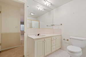 Bathroom with toilet, vanity, and walk in shower