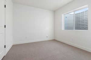 Spare room featuring light colored carpet