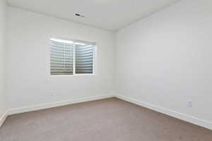 Spare room featuring carpet floors