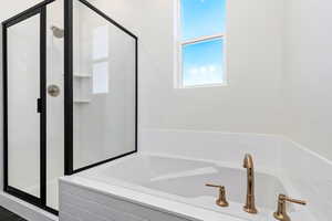 Primary bathroom with a double vanity and seperate tub and shower