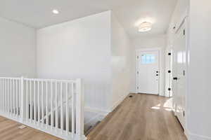 Foyer entrance with light hardwood / wood-style floors