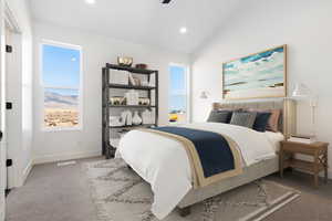 Bedroom with lofted ceiling and carpet floors