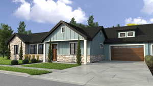 View of front of home featuring stone siding, driveway, and board and batten siding