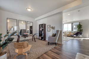 Office area with hardwood / wood-style floors and ceiling fan