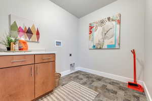 Laundry area with cabinets, washer hookup, a textured ceiling, and electric dryer hookup