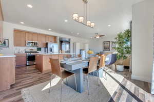 Dining space with dark hardwood / wood-style flooring and ceiling fan