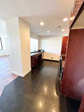 Kitchen with sink and dark tile patterned flooring