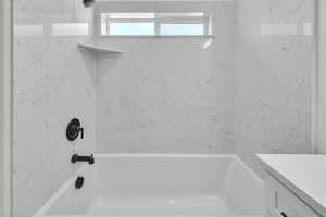 Master full bathroom with a soaking tub and vanity