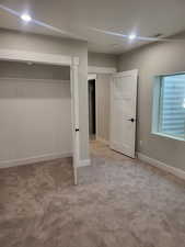 4th bedroom with light carpet