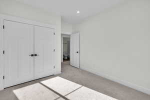 Bedroom 3 featuring recessed lighting, a closet, baseboards, and light carpet