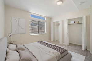 Carpeted bedroom featuring two closets