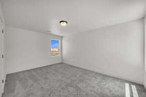 Unfurnished room featuring light carpet