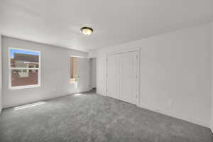 Unfurnished bedroom with carpet floors and a closet