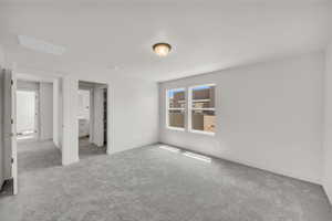 Unfurnished bedroom featuring light colored carpet