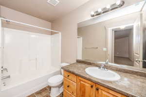 Full bathroom featuring tile patterned floors, vanity, toilet, and bathing tub / shower combination