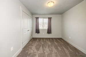 Unfurnished bedroom with carpet and a closet