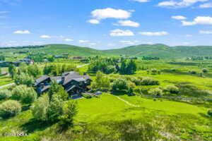 Birds eye view of property with a mountain view and a rural view