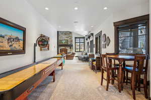 Recreation room with carpet flooring and a fireplace