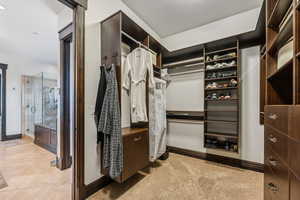 Spacious closet with light colored carpet